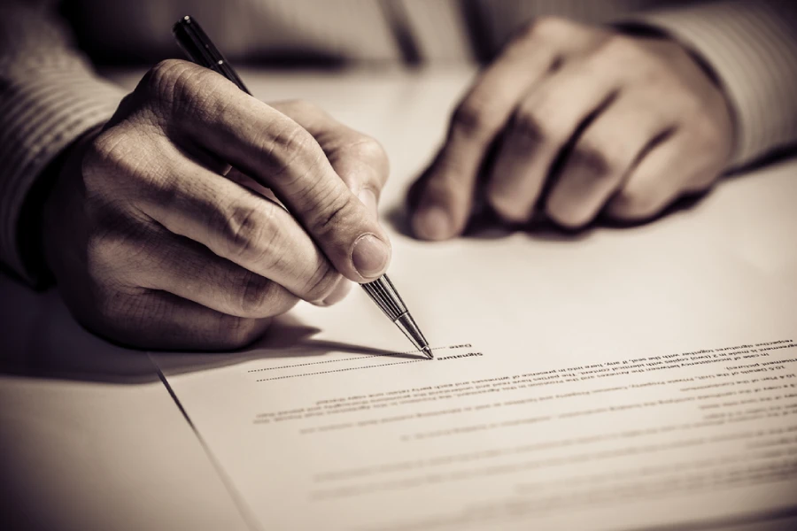 Person signing a legal contract